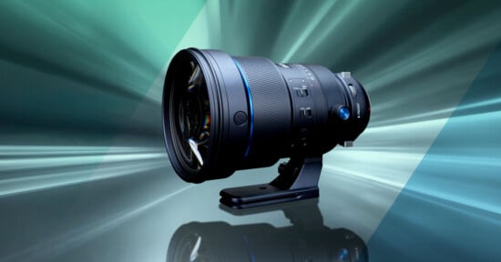A professional camera lens with a tripod mount displayed against a dynamic, abstract background with teal and blue light streaks.