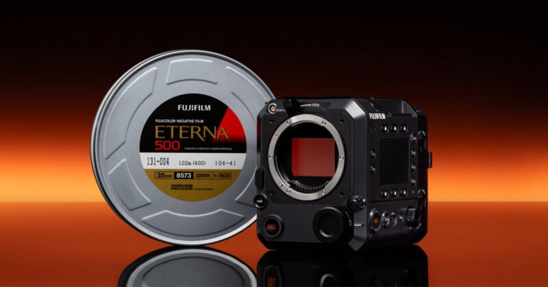 A Fujifilm Eterna 500 film canister stands next to a Fujifilm digital cinema camera body on a reflective surface, with a gradient orange and black background.