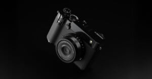 A sleek, black digital camera with a lens and various control dials is displayed on a dark background, showcasing its modern and minimalist design.