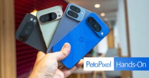 A hand holds four Google Pixel 8a smartphones in different colors—black, green, gray, and blue—displaying their rear cameras. The Petapixel Hands-On logo is overlaid in the bottom right corner.