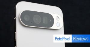 Close-up of the rear camera module on a white smartphone with three lenses and a flash, featuring a "PetaPixel Reviews" banner in the bottom right corner.