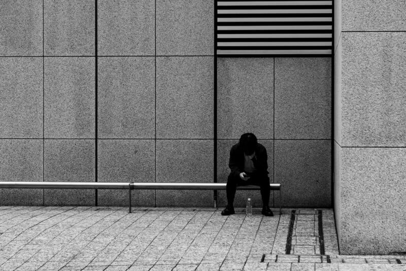 A man sitting on a bench.