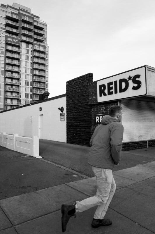 A man standing on the sidewalk.