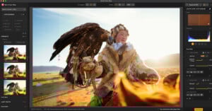 A person in traditional attire holds a large bird of prey, possibly an eagle, on their gloved arm in a sunlit outdoor setting, with image editing software interface visible on screen.