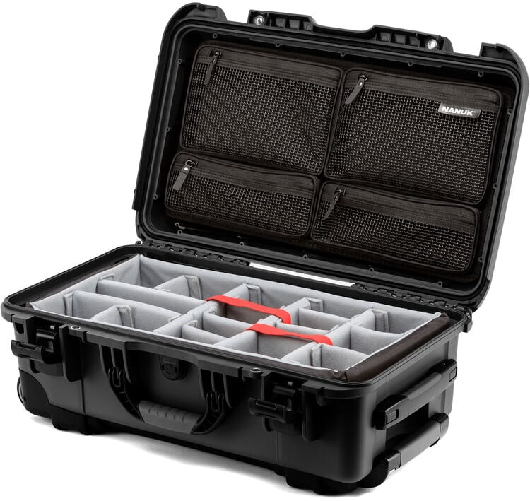 A hard-shell black carrying case with an open lid, showing padded, adjustable compartments inside and mesh zippered pockets on the underside of the lid.
