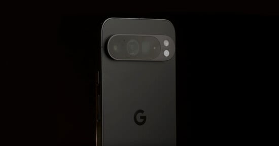 A close-up of the back of a black Google Pixel phone against a dark background, showing the camera bar with multiple lenses and the Google "G" logo below.