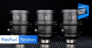 Three black camera lenses are arranged side by side on a grid-patterned surface, with “Petapixel Reviews” and “Editors' Choice” badges displayed in the image corners.