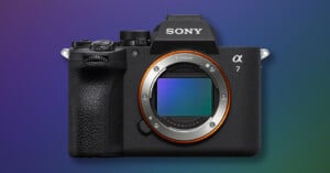 A Sony Alpha 7 mirrorless camera with a black body and no lens attached, shown against a blue and purple gradient background.