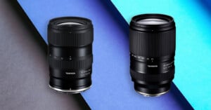 Two Tamron camera lenses are displayed on a diagonal background with dark gray and bright blue contrasting colors. The lenses are positioned upright, showcasing their detailed markings and textured focus rings.