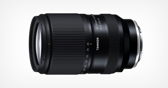 A Tamron camera lens with a black, ribbed zoom ring and clear white markings for focal lengths and aperture, shown against a plain white background. The Tamron logo is printed in white on the lens barrel.